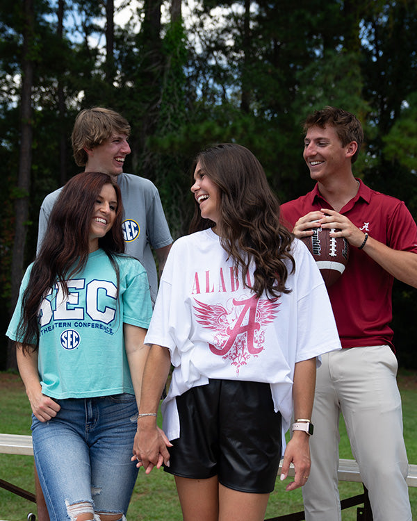 group of friends posing for a picture in collegiate gear