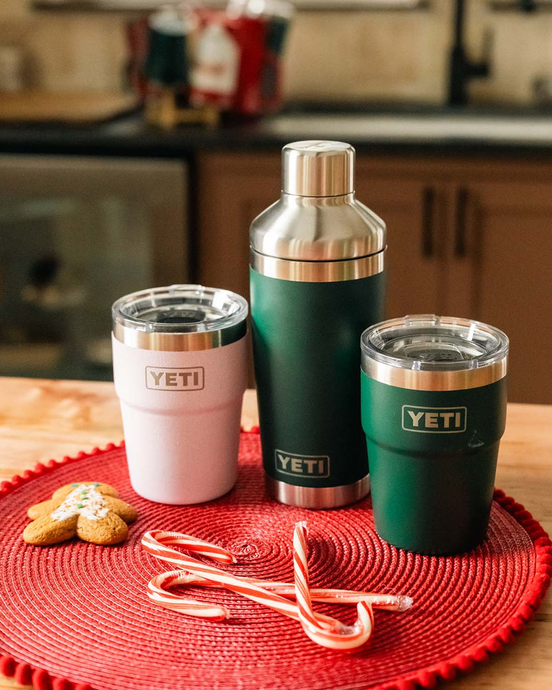 Three YETI products in a kitchen setting with candy canes and a gingerbread cookie.
