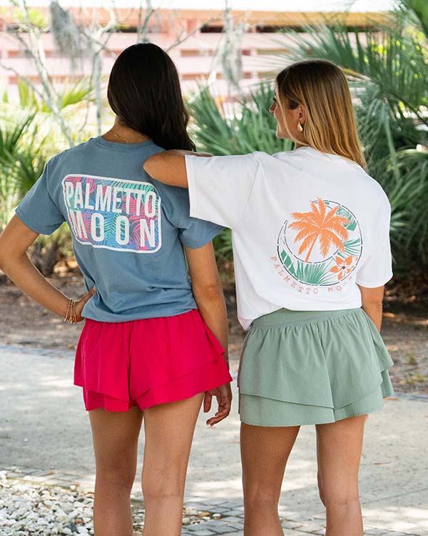 two girls posing for a picture wearing palmetto moon t-shirts