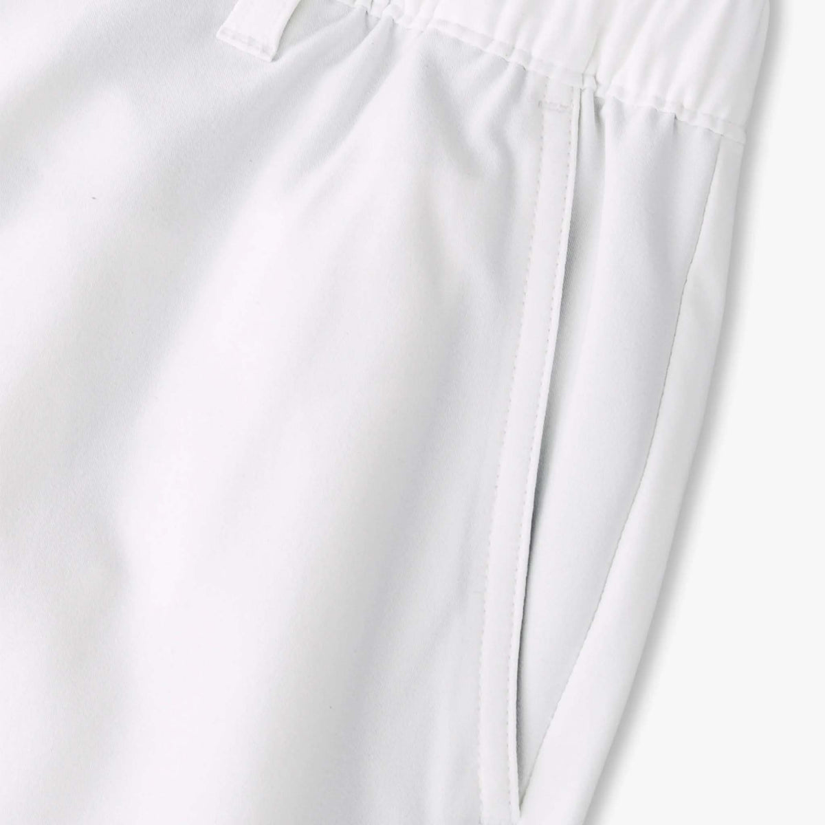 Close-up of white shorts with a plain background