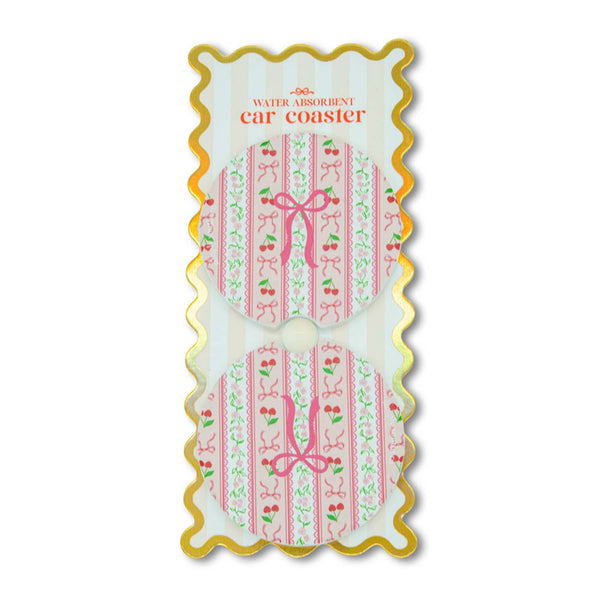 Decorative car coaster with pink design on a white background