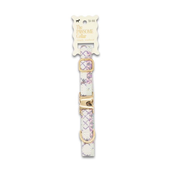 Dog collar with floral pattern and gold buckle on a white background