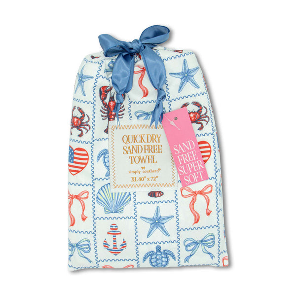 Patterned Pouch with Americana coastal themed patches containing a quick dry sand free towel measuring 40"x72" by Simply Southern