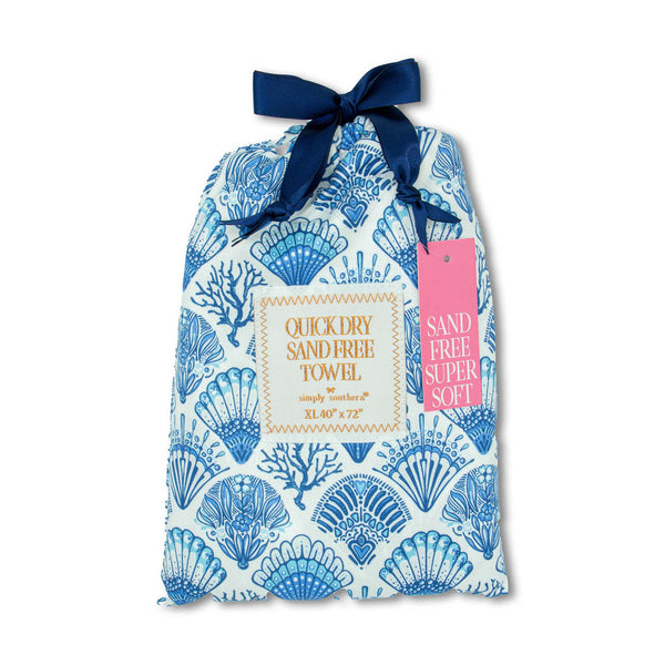 Patterned Pouch with multiple blue sculpted shells and coral in blue containing a quick dry sand free towel measuring 40"x72" by Simply Southern