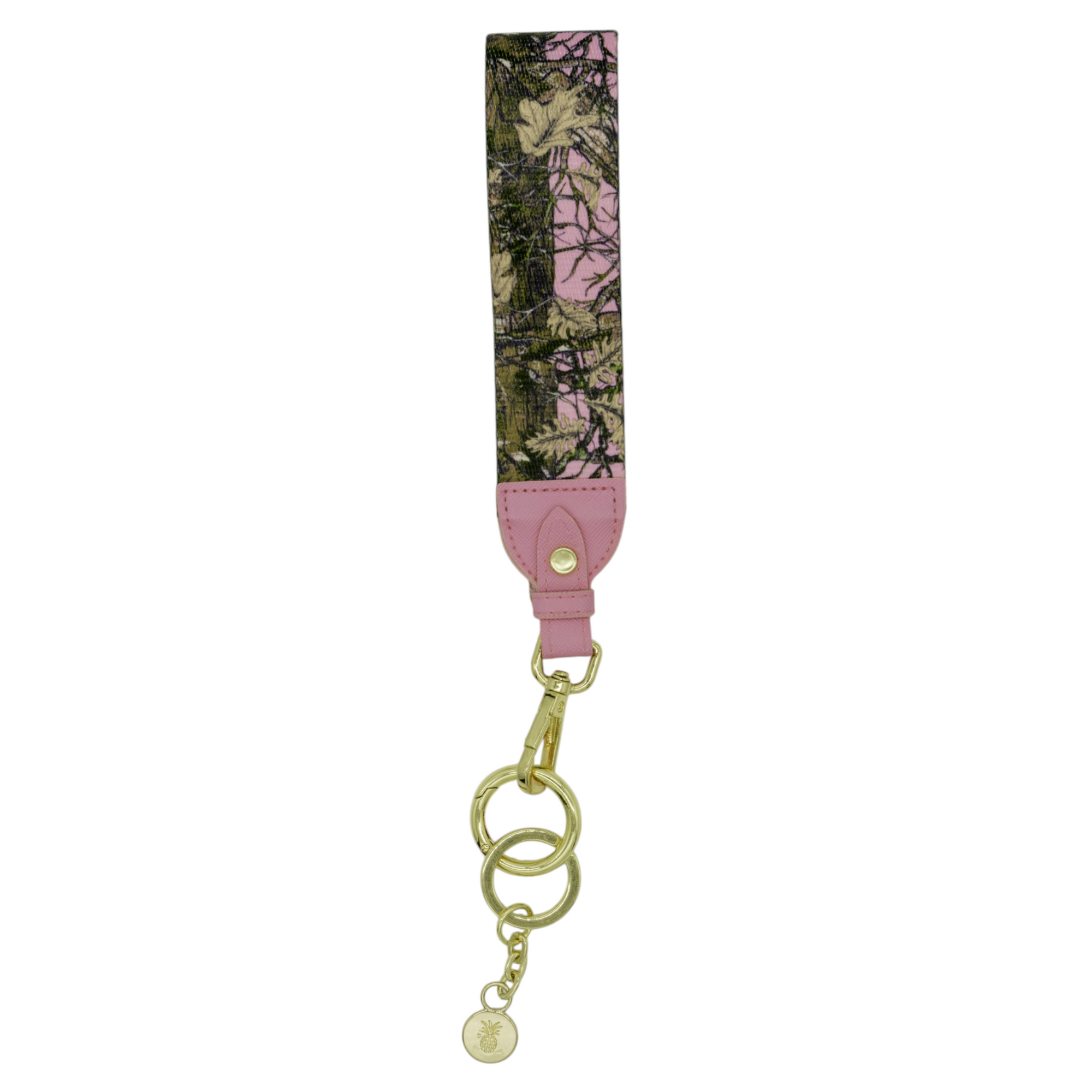 Pink camo key fob with pink leather accent and gold hardware featuring clasp, key rings, and small charm.