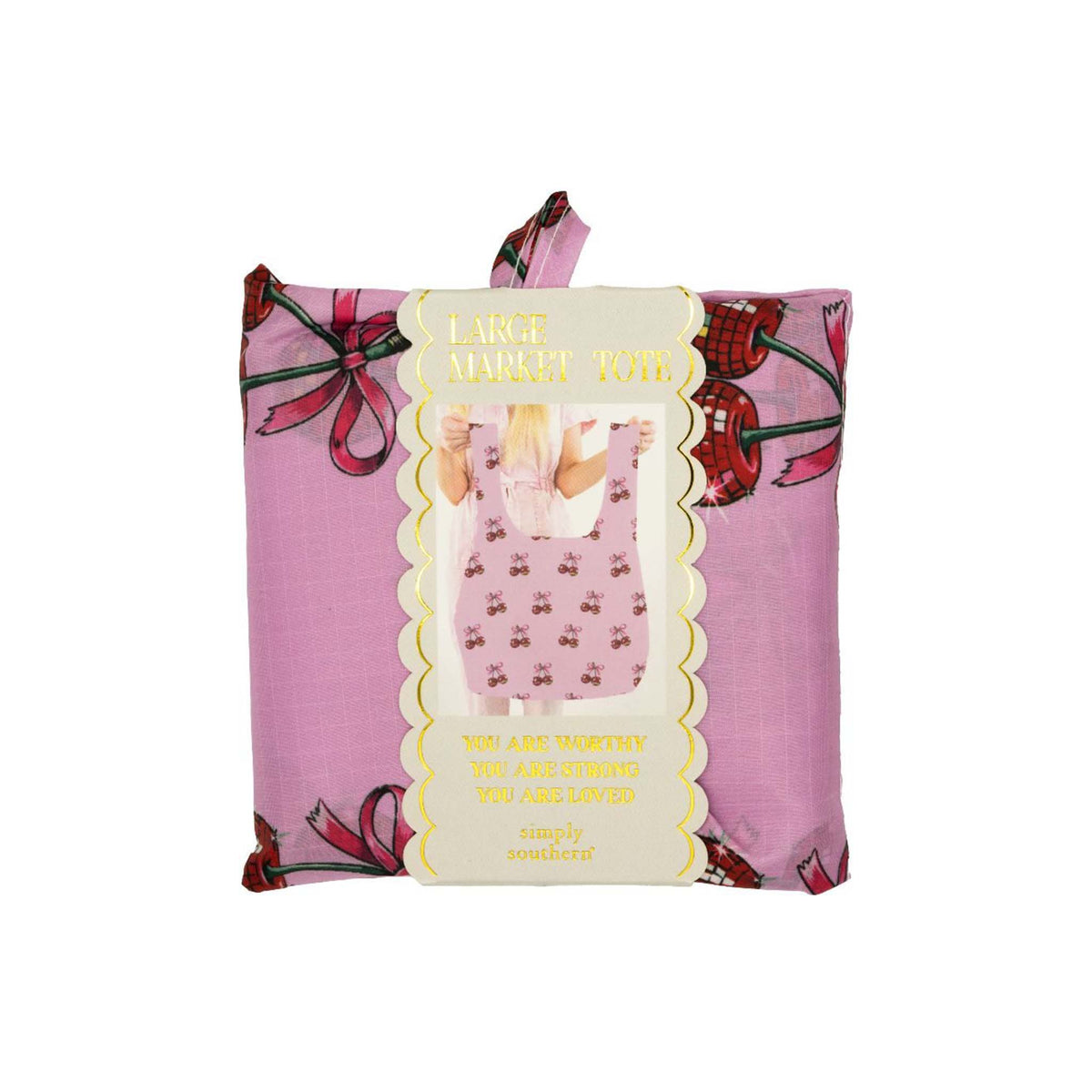 Simply Southern Large Market Tote in pink cherry bow print, shown folded in packaging with gold scalloped label and inspirational quote.