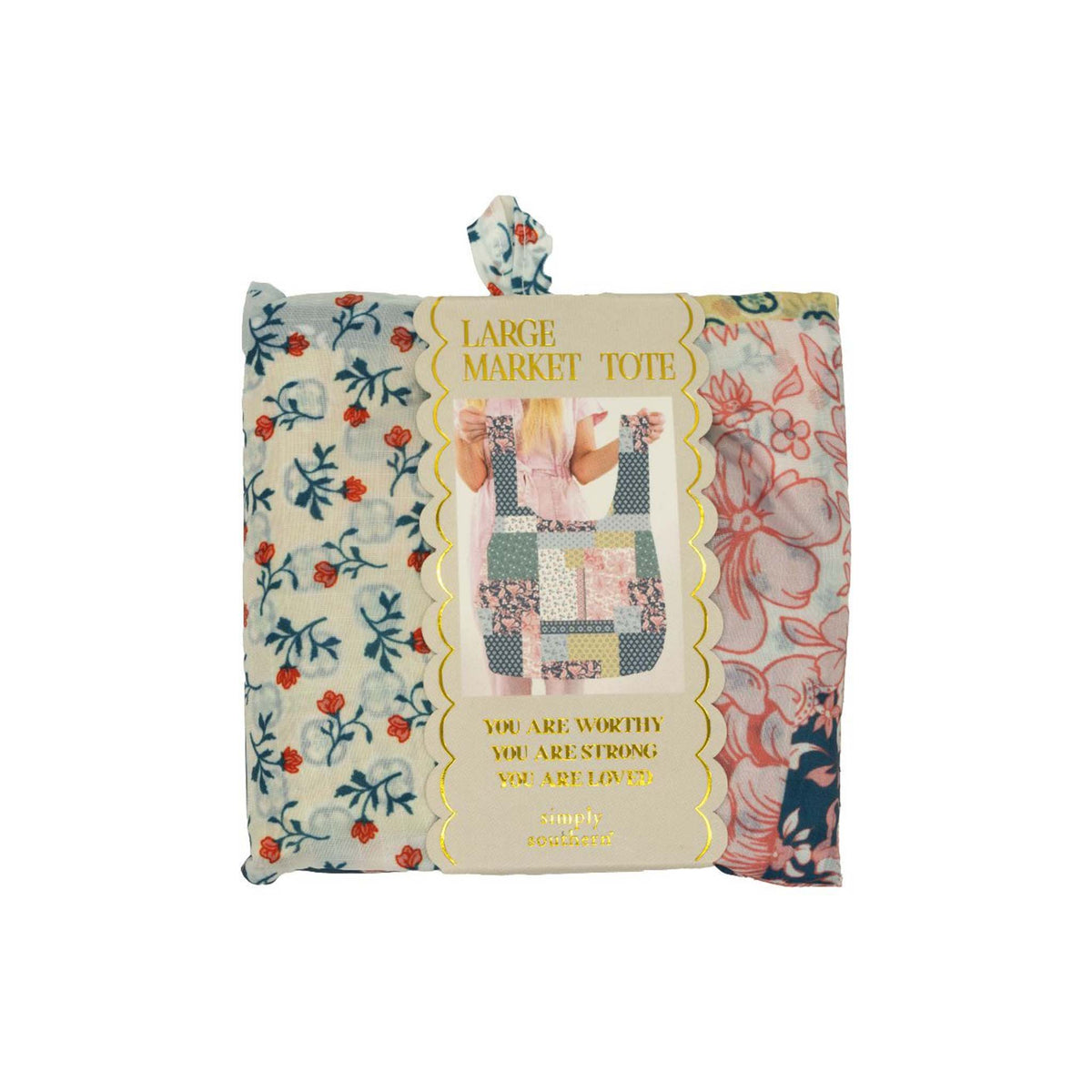 Simply Southern Large Market Tote in multicolor quilt patchwork design, shown folded in packaging with gold scalloped label and inspirational quote.