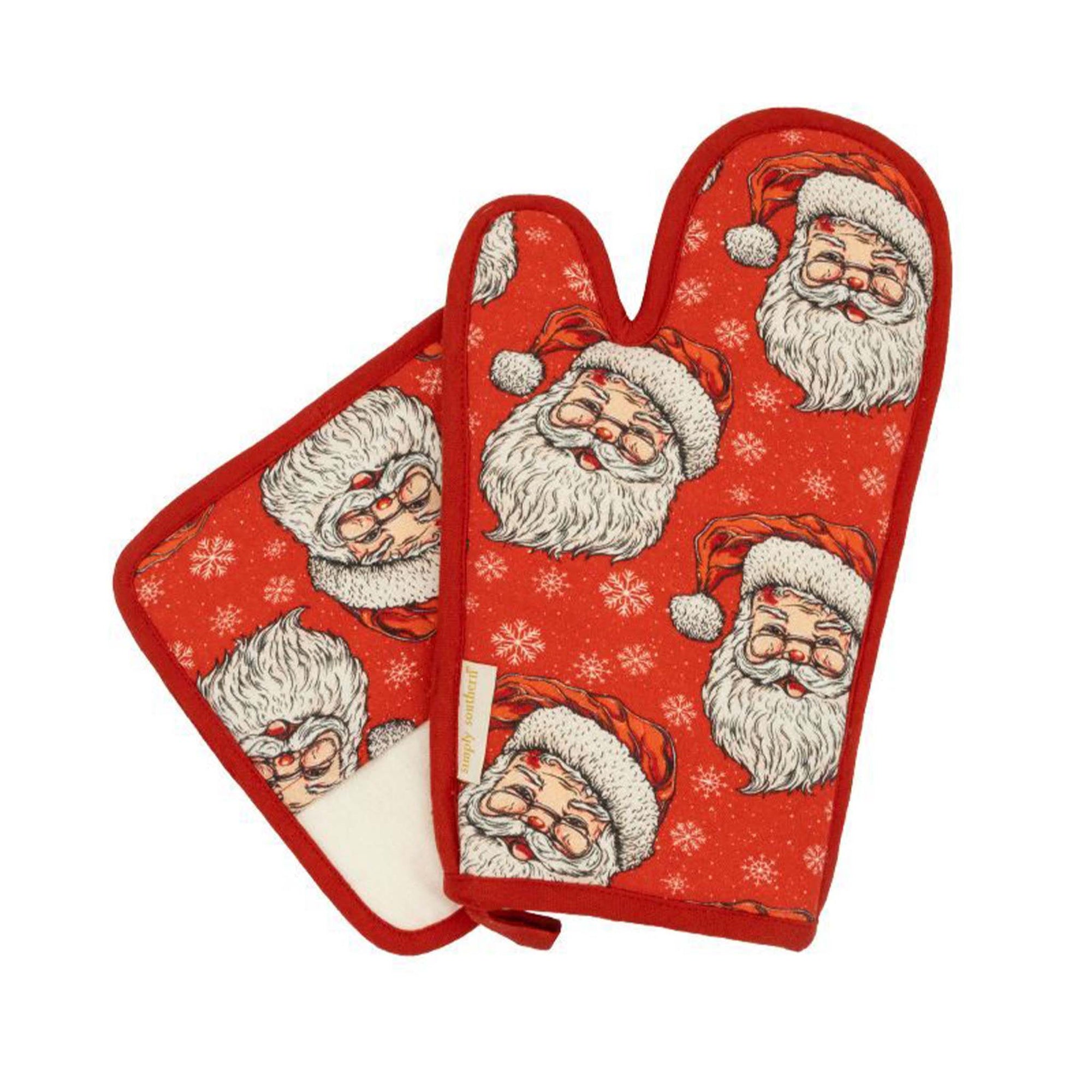 Simply Southern red oven mitt and pot holder set with allover Santa Claus and snowflake print, trimmed in red with hanging loops.