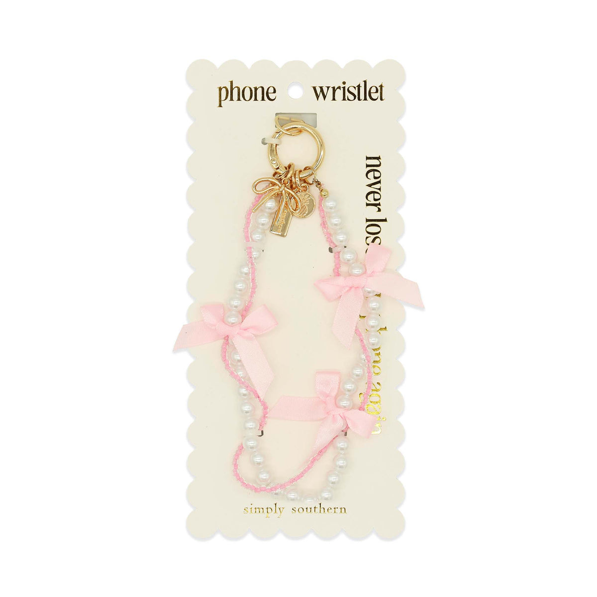 Simply Southern pink beaded phone wristlet with ribbon bows and gold clip on display card.