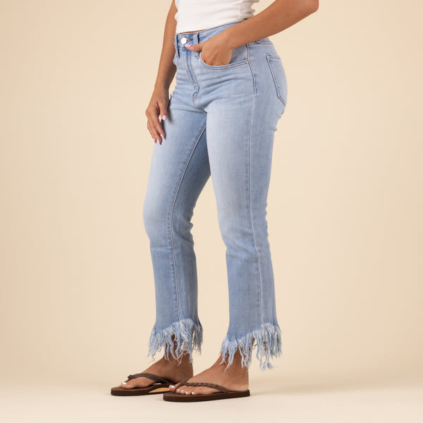 Side view of the light-wash cropped jeans showing a relaxed, slightly tapered fit with frayed hems at the ankles. The denim has a soft fade with whiskering near the hips.