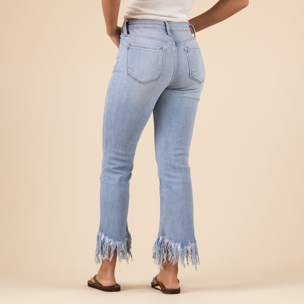 Back view of the slightly cropped light-wash jeans featuring classic back pockets, a mid-rise waistband, and frayed hems. The denim has a soft fade and clean stitching along the seams.