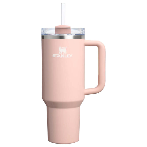 Stanley 40oz tumbler in Peach Whip Gloss, a pastel peach-colored stainless steel tumbler with a sleek, tapered design, a clear lid, and a reusable straw.