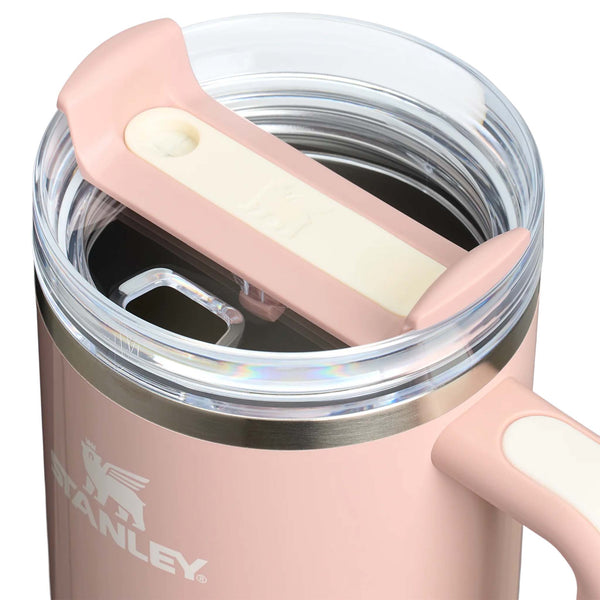 Stanley 40oz tumbler in Peach Whip Gloss, a pastel peach-colored stainless steel tumbler with a sleek, tapered design, a clear lid, and a reusable straw.