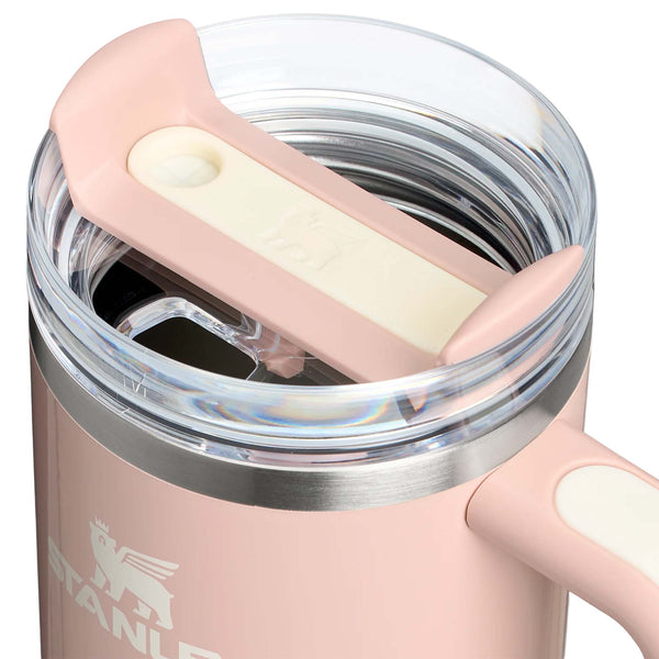 Stanley 30oz tumbler in Peach Whip Gloss, a stainless steel tumbler in a glossy soft blue finish, featuring a sturdy ergonomic handle, a clear lid, and a reusable straw.