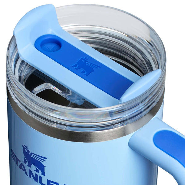 Stanley 30oz tumbler in Cornflower Blue Gloss, a stainless steel tumbler in a glossy soft blue finish, featuring a sturdy ergonomic handle, a clear lid, and a reusable straw.