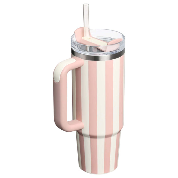 Stanley 30oz handled tumbler in Peach Whip Cabana, a pastel peach-colored stainless steel tumbler featuring a sturdy ergonomic handle, a clear lid, and a reusable straw.
