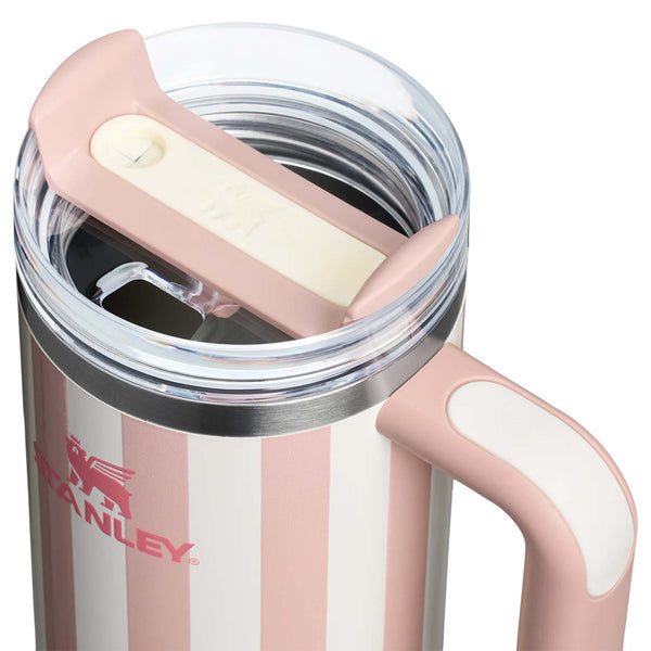 Stanley 30oz handled tumbler in Peach Whip Cabana, a pastel peach-colored stainless steel tumbler featuring a sturdy ergonomic handle, a clear lid, and a reusable straw.
