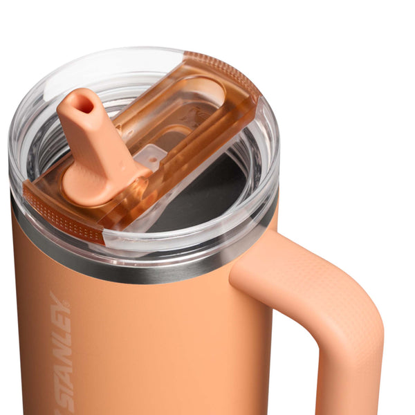 Stanley Pro Tour Leakproof 30oz Tumbler in Apricot, a warm orange stainless steel tumbler with a sleek, tapered design, a leakproof flip-top lid, and a durable ergonomic grip.