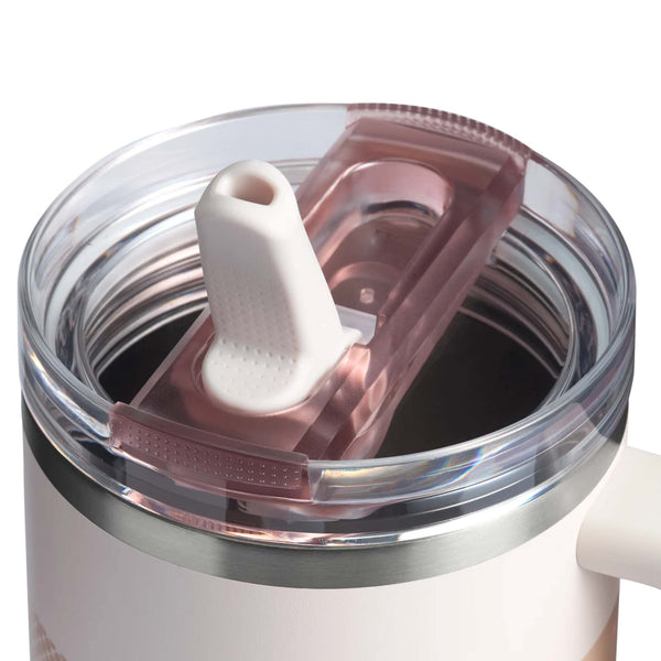 Close-up of Stanley Quencher lid in Rose Quartz Fade with raised white straw and pink-toned rotating cover.