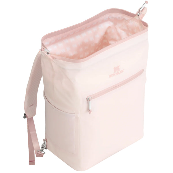 tanley Madeline Midi Backpack Cooler in Rose Quartz shown standing upright. The cooler features a soft pink exterior, adjustable padded backpack straps, a front zippered pocket, and a top handle. Designed for portability and insulation, it is photographed in a studio with a neutral background.