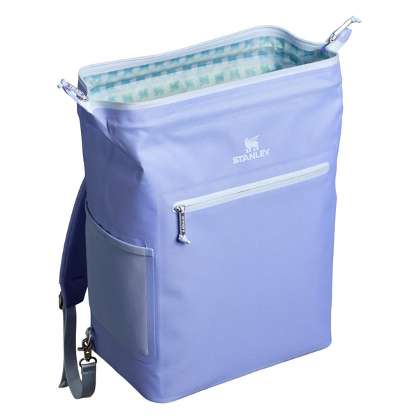 Stanley Madeline Midi Backpack Cooler in Hydrangea shown standing upright. The cooler features a soft purple exterior, adjustable padded backpack straps, a front zippered pocket, and a top handle. Designed for portability and insulation, it is photographed in a studio with a neutral background.