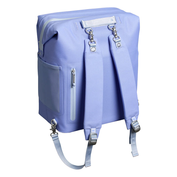 Stanley Madeline Midi Backpack Cooler in Hydrangea shown standing upright. The cooler features a soft purple exterior, adjustable padded backpack straps, a front zippered pocket, and a top handle. Designed for portability and insulation, it is photographed in a studio with a neutral background.