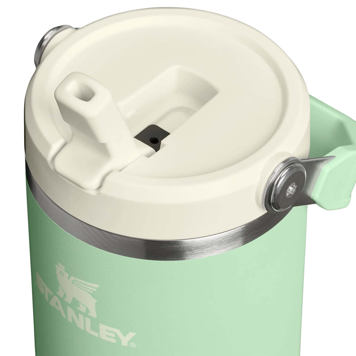 Close-up of Stanley Pistachio Quencher tumbler lid with cream flip straw and stainless steel trim.