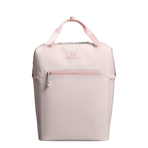 Stanley Madeline Mini Backpack Cooler in Rose Quartz shown standing upright. The compact cooler features a soft pink exterior, adjustable padded backpack straps, a front zippered pocket, and a top carry handle. Designed for lightweight portability and insulation.