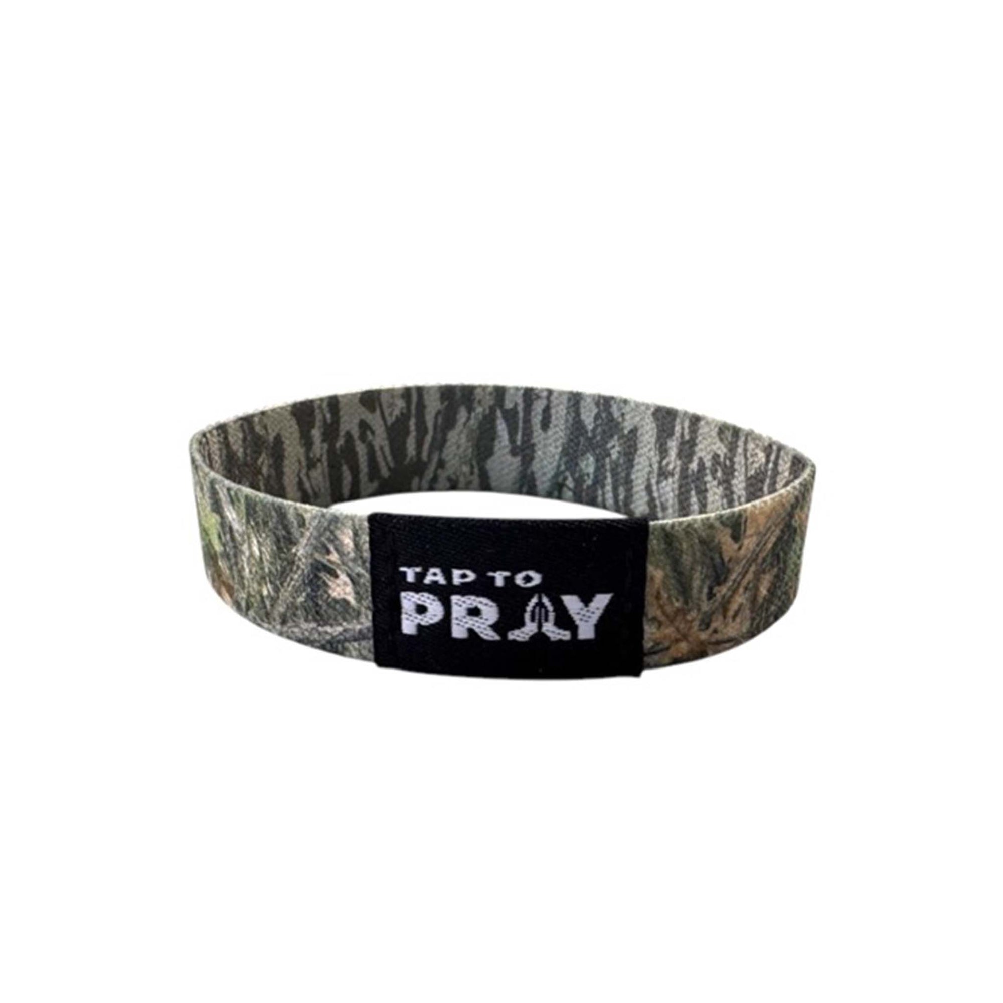 Tap to Pray Treebark Camo Wristband shown from front with black patch featuring white text and praying hands icon.