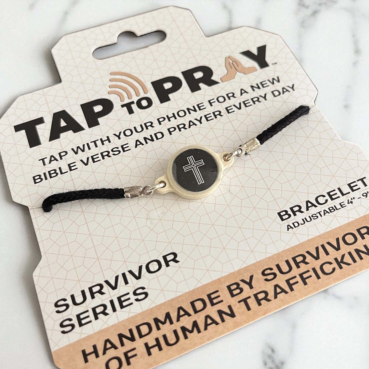 Bracelet with cross design on a 'Tap to Pray' card with text about the product and its purpose.