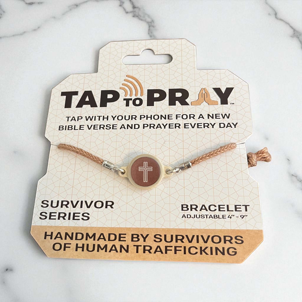 Bracelet on a 'Tap to Pray' packaging with marble background