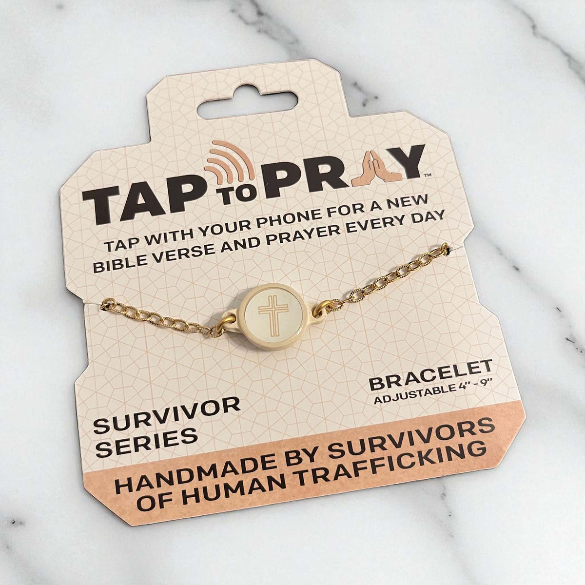 Gold bracelet on a 'Tap to Pray' packaging with text about the brand and product details.