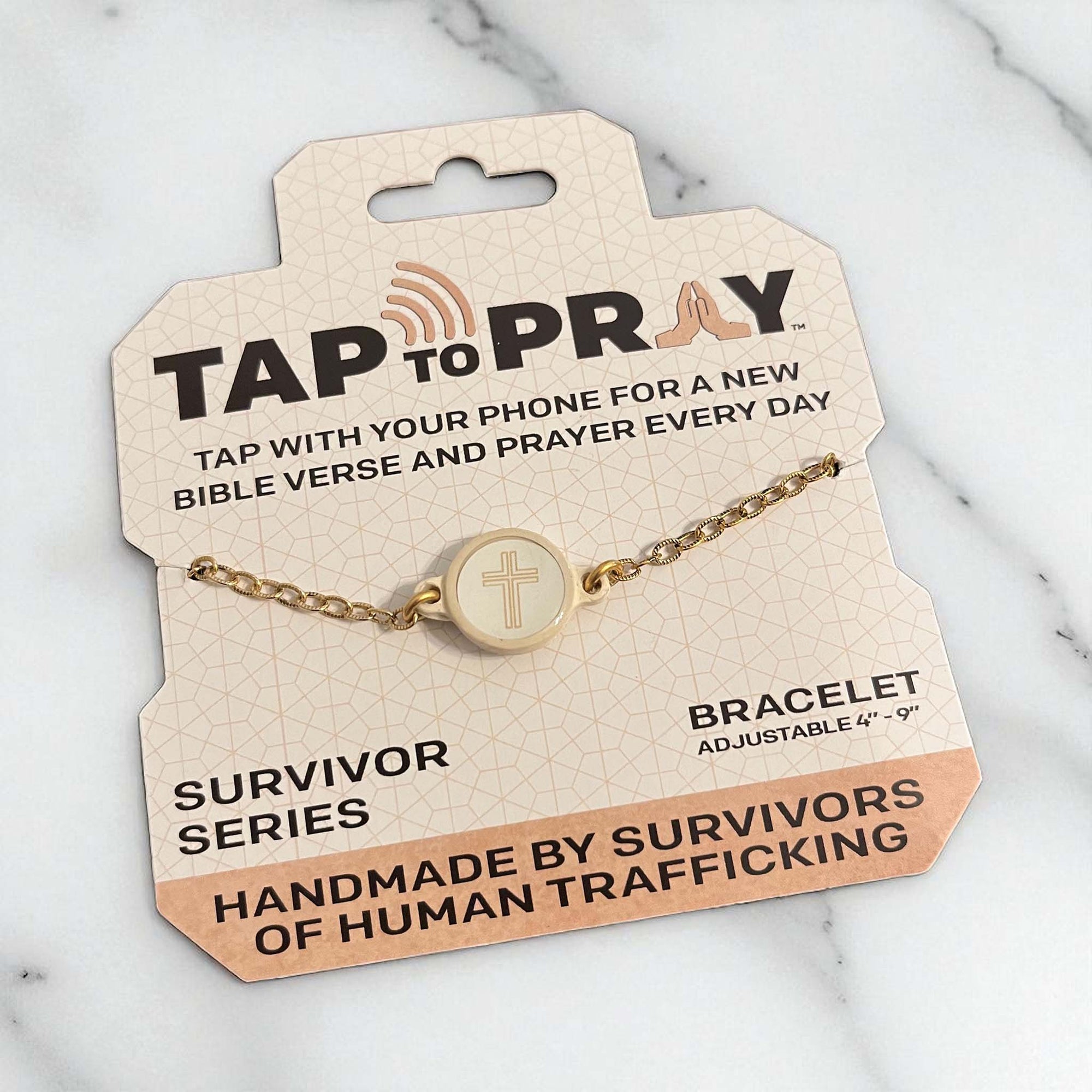 Gold bracelet on a 'Tap to Pray' packaging with text about the brand and product details.