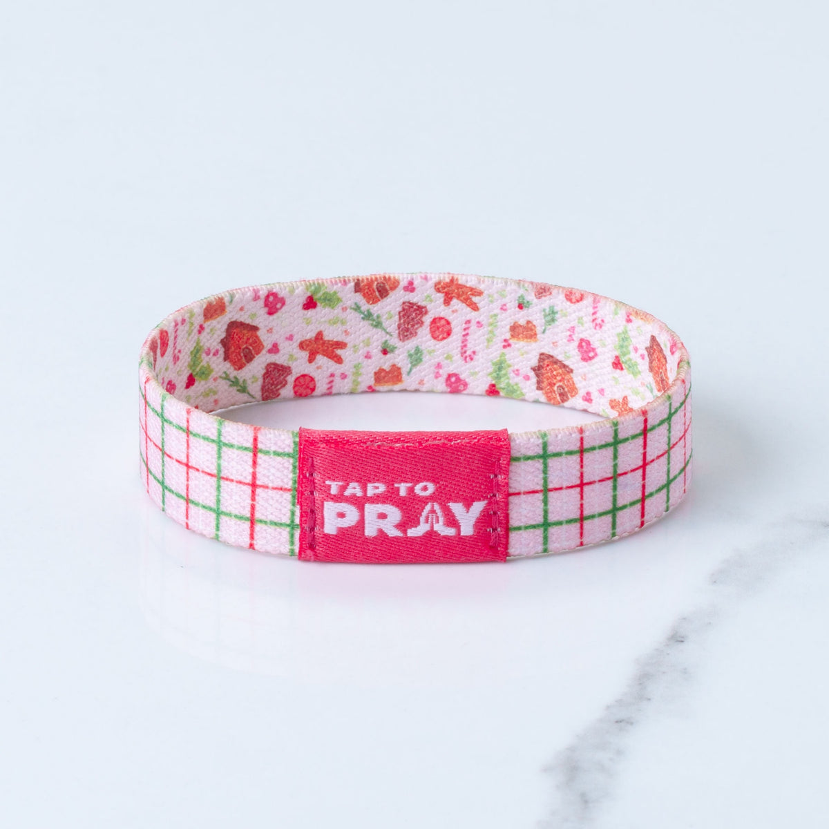 Tap To Pray reversible bracelet with a pink red and green plaid on one side and a gingerbread print on reverse side.