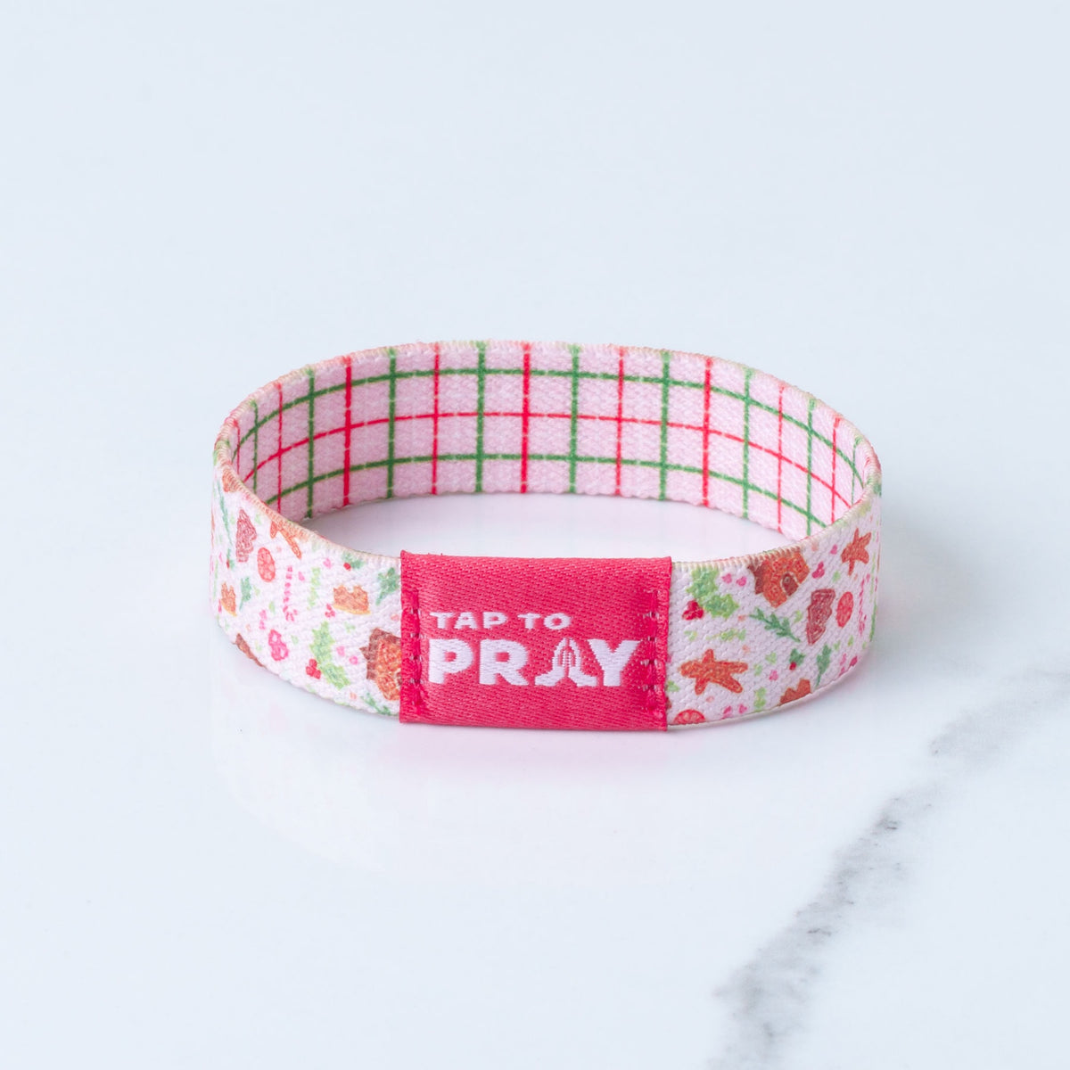 Tap To Pray reversible bracelet with a pink red and green plaid on one side and a gingerbread print on reverse side.