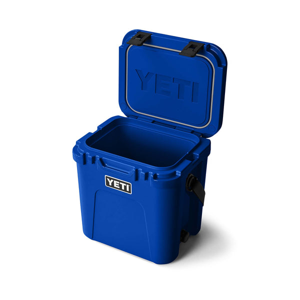 Blue YETI cooler with open lid on a white background