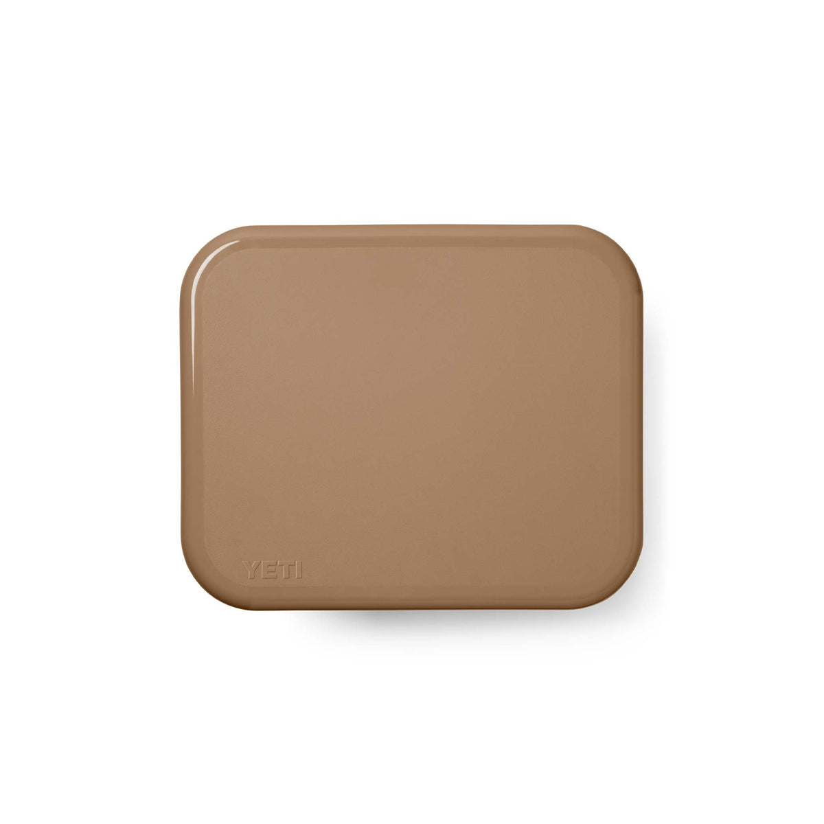 Top-down view of cooler with tan lid closed, showing smooth flat surface and debossed YETI logo in corner.