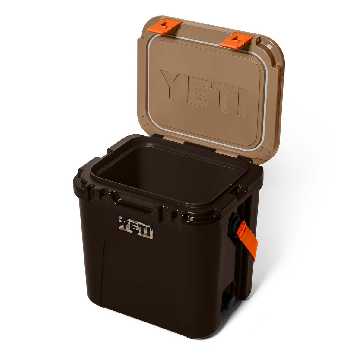 Cooler shown open with tan lid lifted, revealing empty interior and large YETI logo embossed on lid.