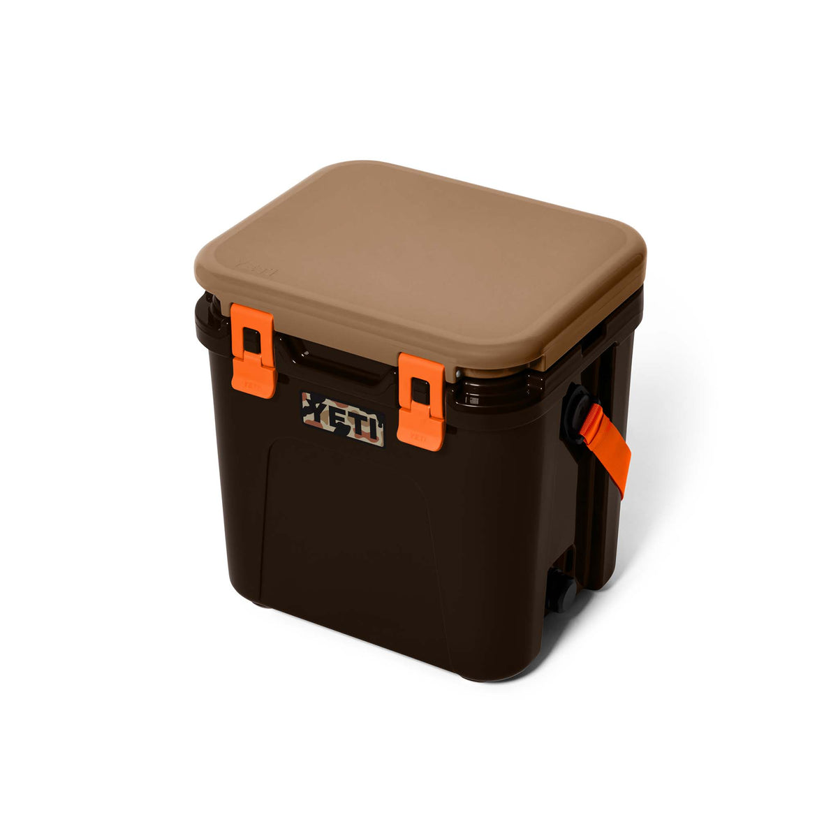 Angled front view of the cooler with tan lid closed and two orange latches above a YETI camo logo.