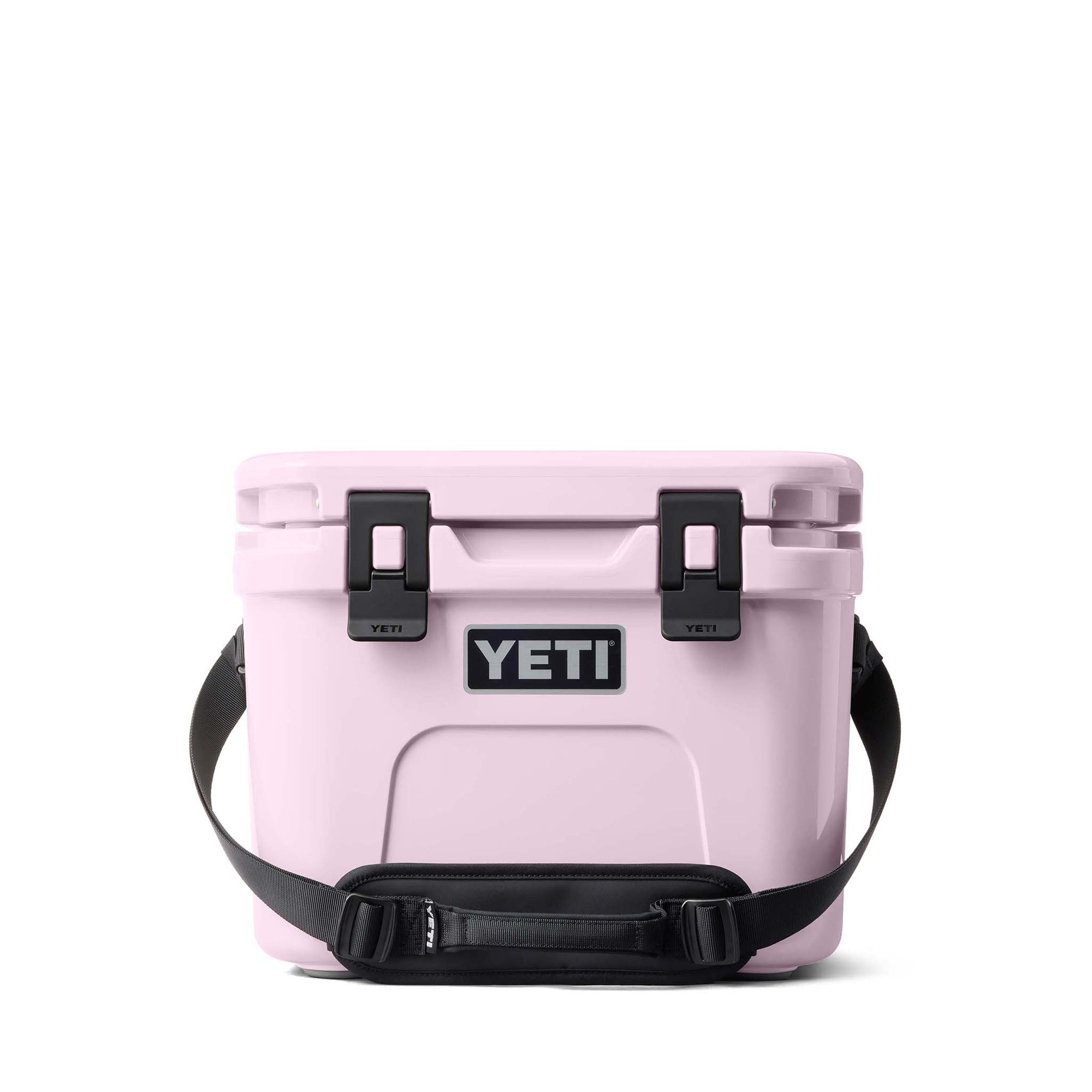 Front view of the YETI Roadie 15 Cooler in Cherry Blossom with closed lid, latches, and padded shoulder strap.