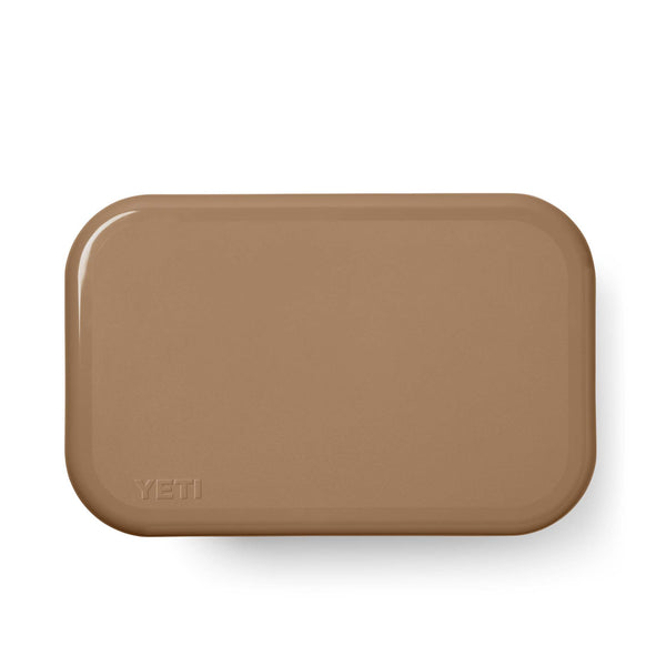 Close-up view of the lid from the YETI Roadie15 Cooler in tan with embossed YETI logo.