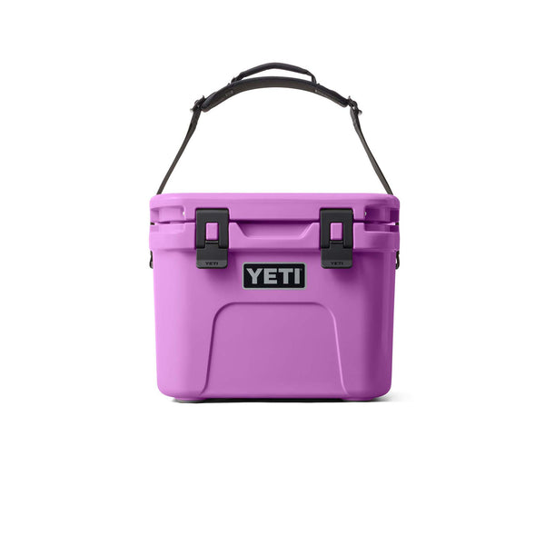 Purple YETI cooler with black straps on a white background