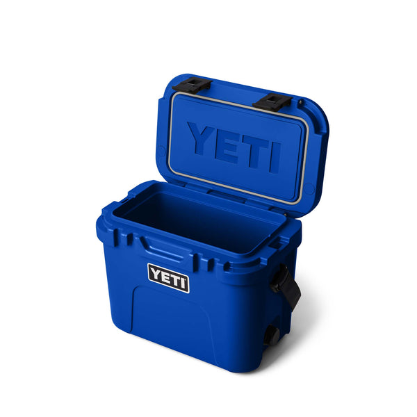 Blue YETI cooler with open lid on a white background