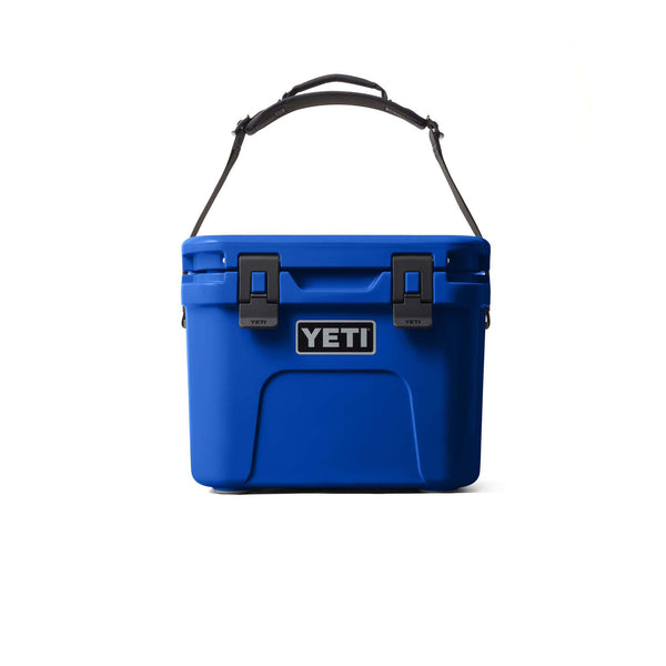 Blue YETI cooler with a strap on a white background