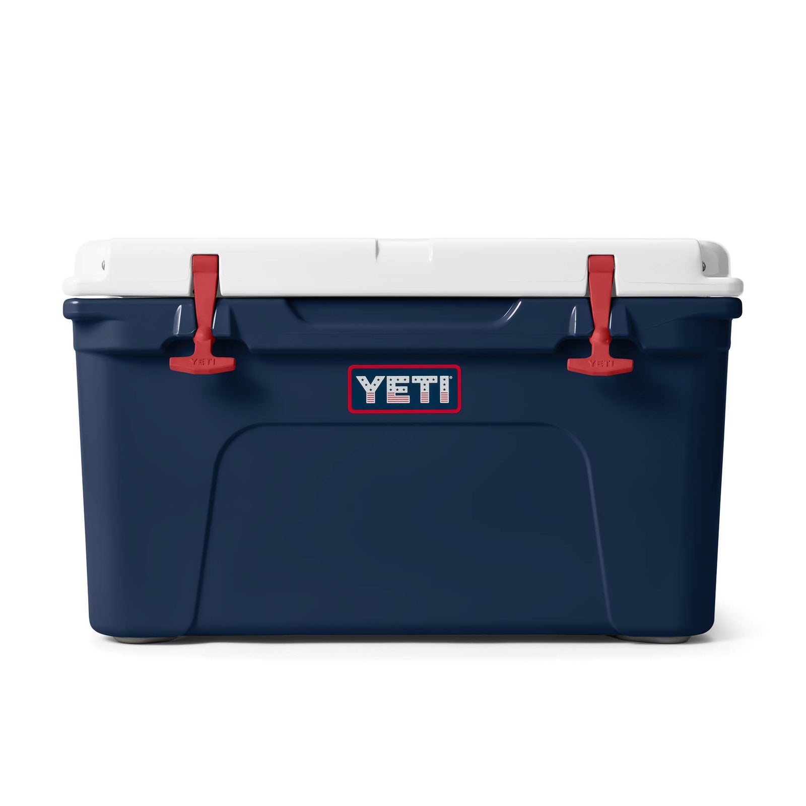YETI Tundra 45 hard cooler in a striking patriotic colorway, showcasing a deep navy blue body, bright rescue red T-latches and side handles, and a clean white lid. The cooler has a durable, rotomolded design with thick insulation, built for heavy-duty use and excellent ice retention. Its rectangular shape and rugged construction make it ideal for camping, boating, or backyard gatherings.