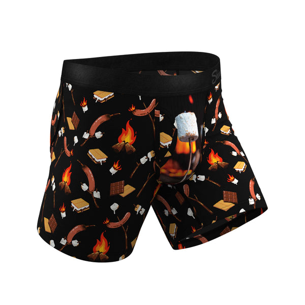 Angled view of black boxer briefs with marshmallow roasting graphic and camp-themed pattern.