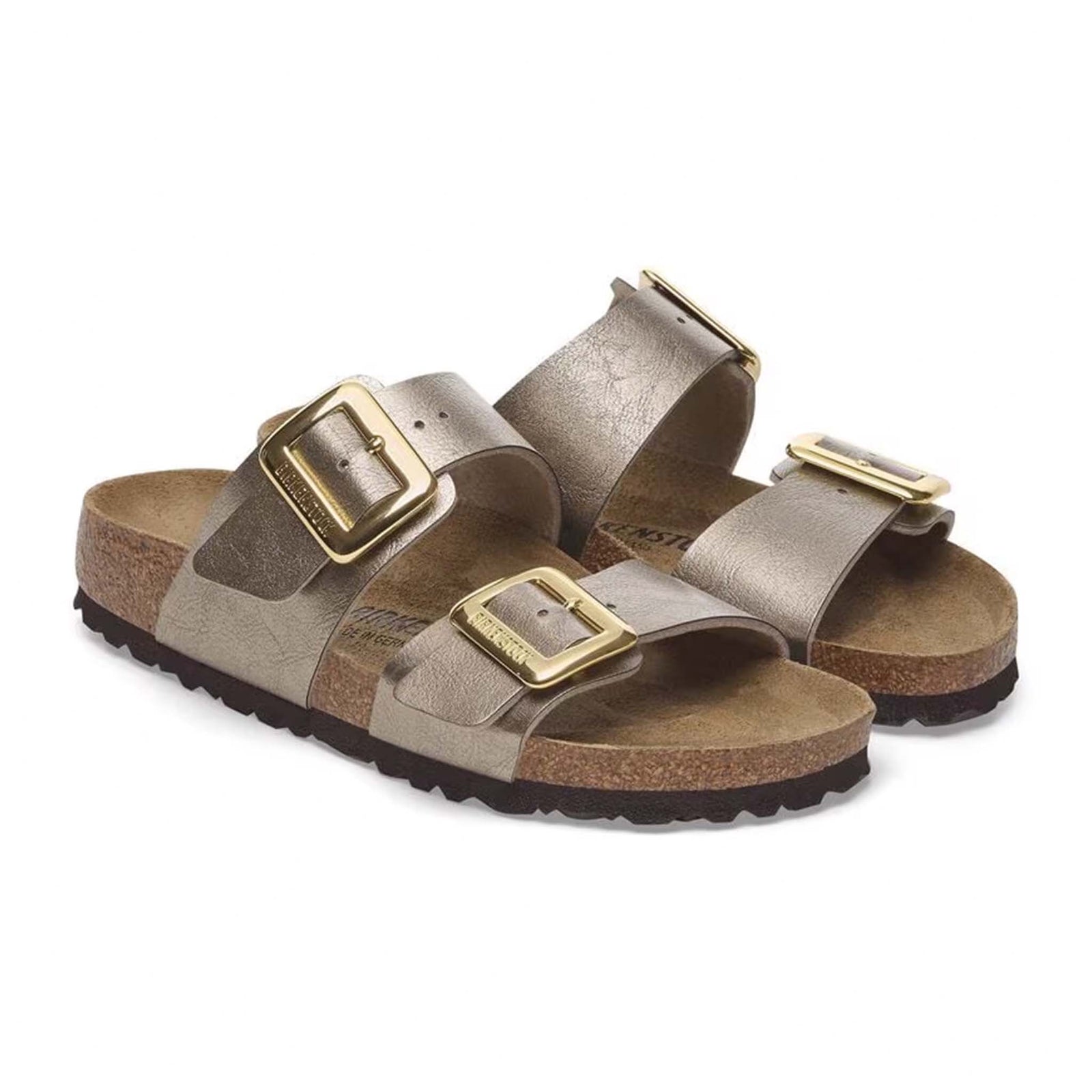 Birkenstock Sydney Luxe Buckle Sandals in Taupe, sizes 5/36, 6/37, 7/38, 8/39, 9/40, 10/41, 11/42. Both sandals angled diagonally to highlight front and side details, with a focus on the shiny gold buckles.