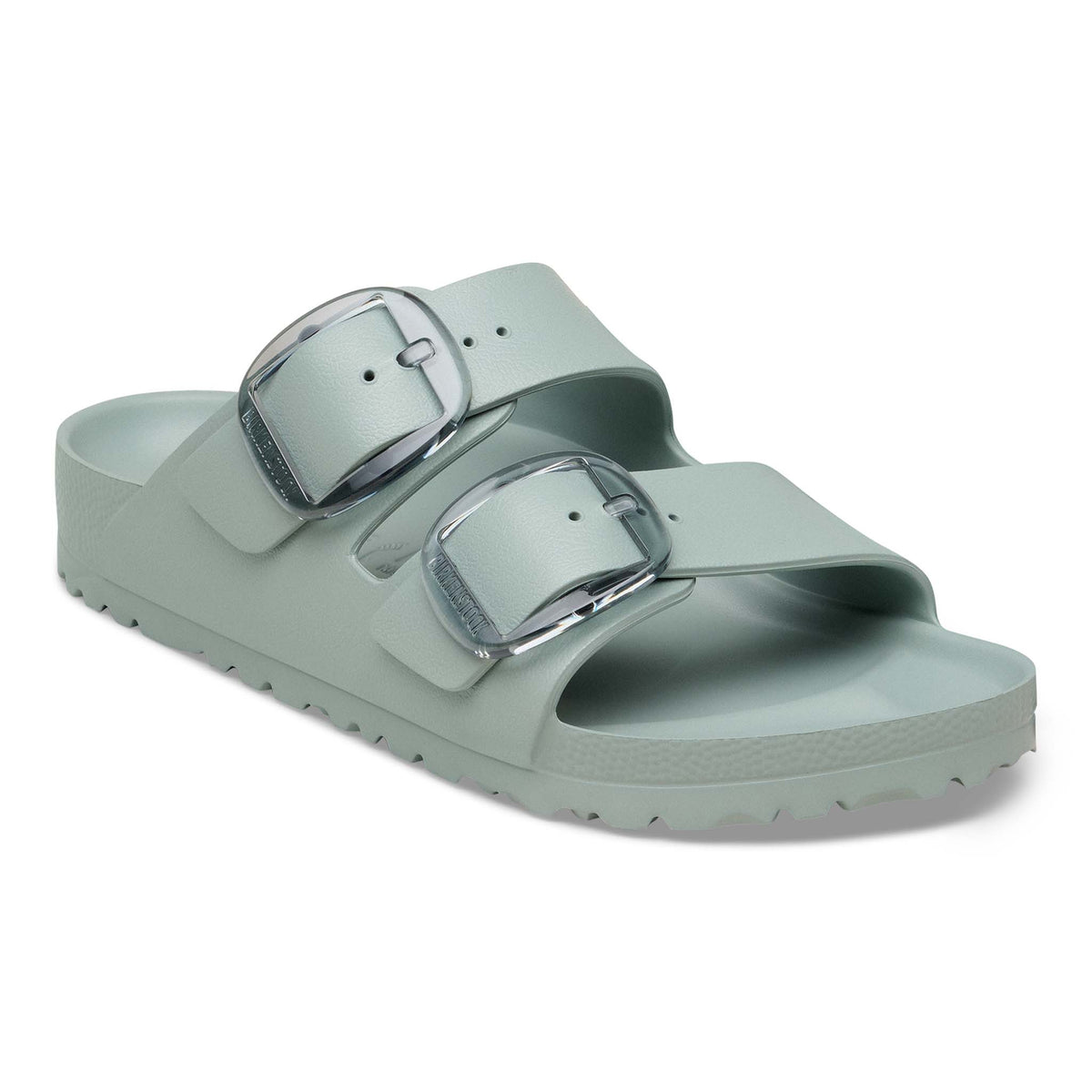 Birkenstock Arizona EVA sandals in Pure Sage with two adjustable straps and translucent oversized buckles, angled product view on a white background.