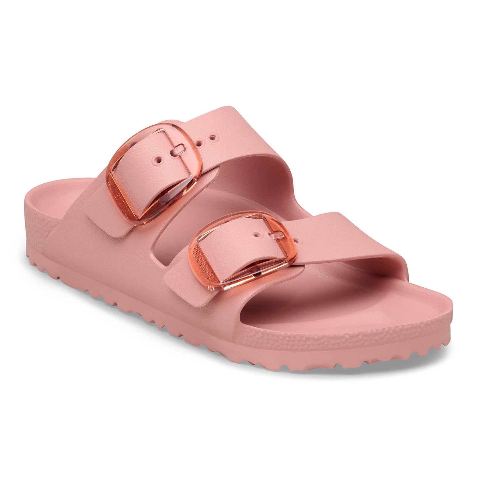 Birkenstock Arizona EVA sandals in Pink Clay with two adjustable straps and translucent oversized buckles, angled product view on a white background.