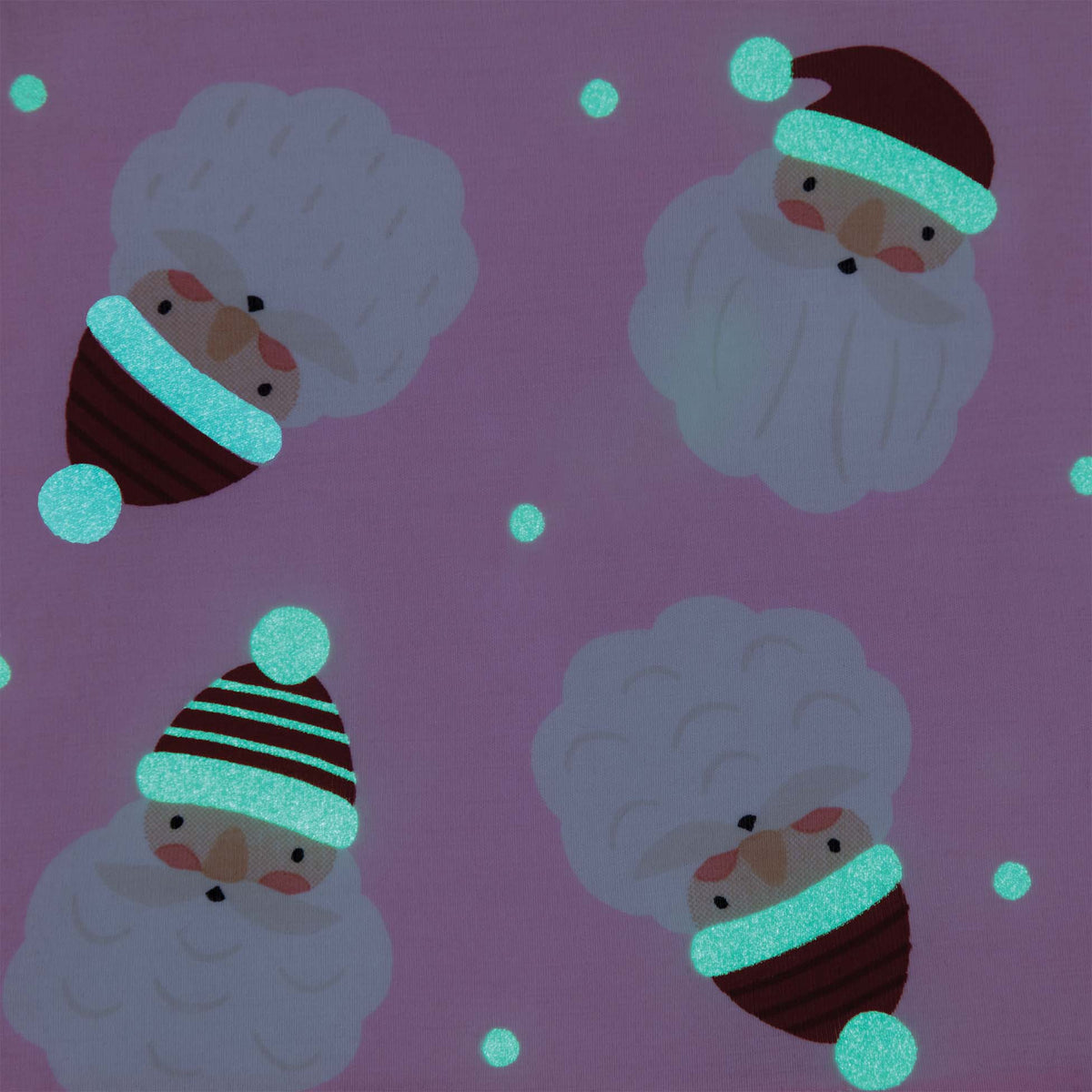 Close-up of pink fabric showing Santa face print with glowing hats and snowballs in the dark.